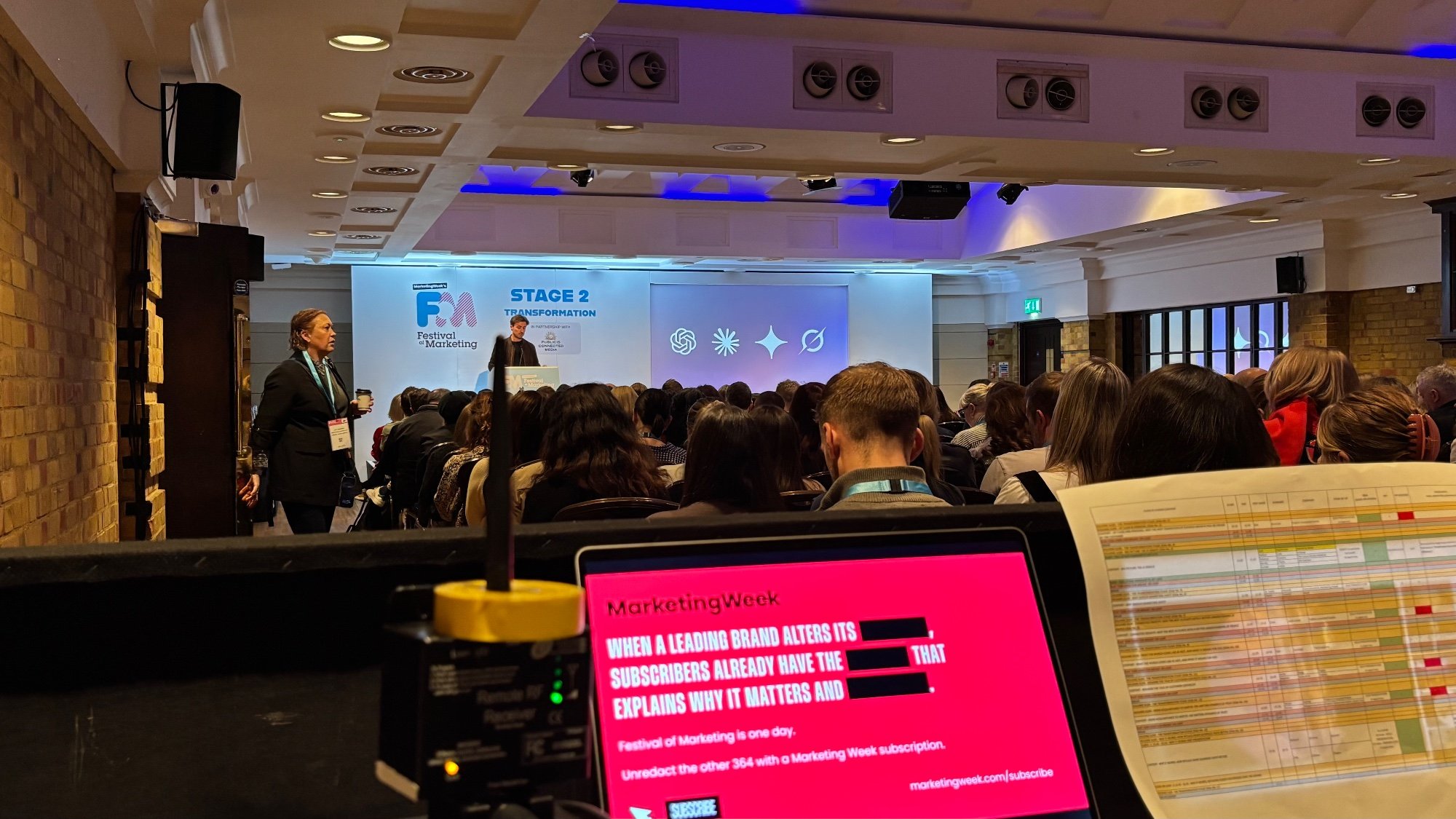 Conference session in progress, viewed from the technical desk at the back of the room
